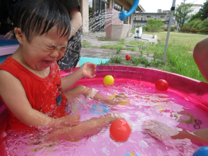 水がかかって目をつぶっている子